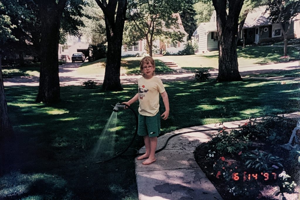 Sean watering lawn in Richfield in 1997